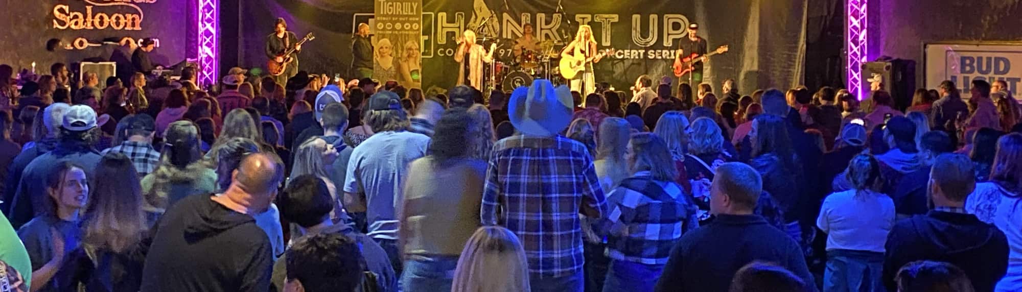 country concert with fans wearing cowboy hats Phoenix
