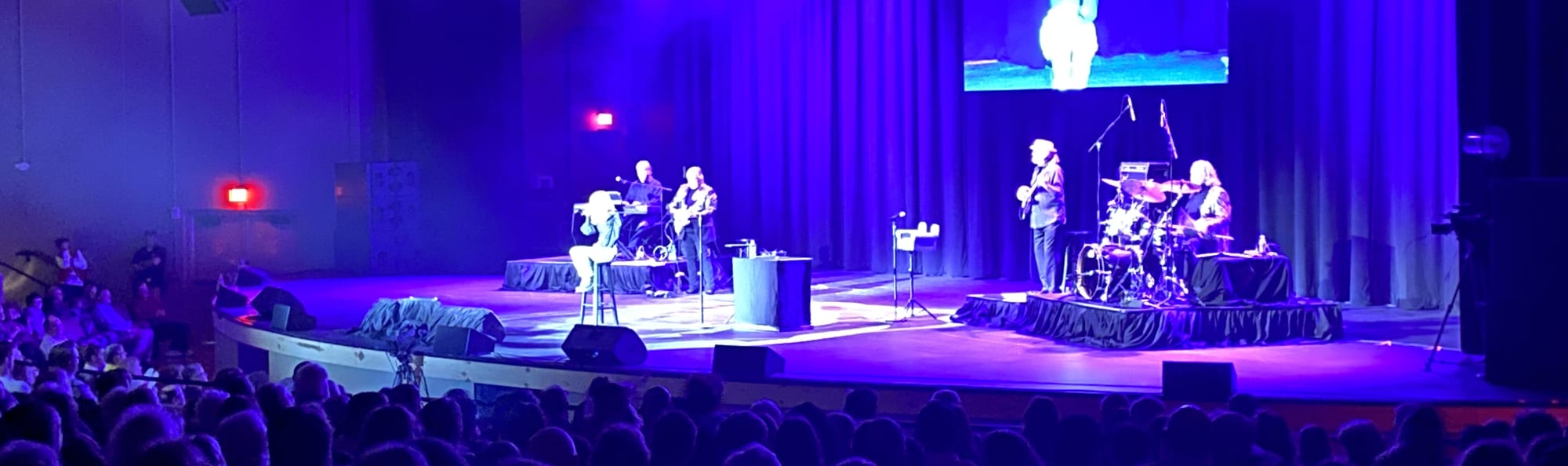 signer on stage in chair washed out by the lights Phoenix